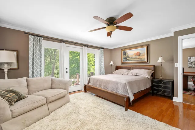 a bedroom with a large bed couch and a large window