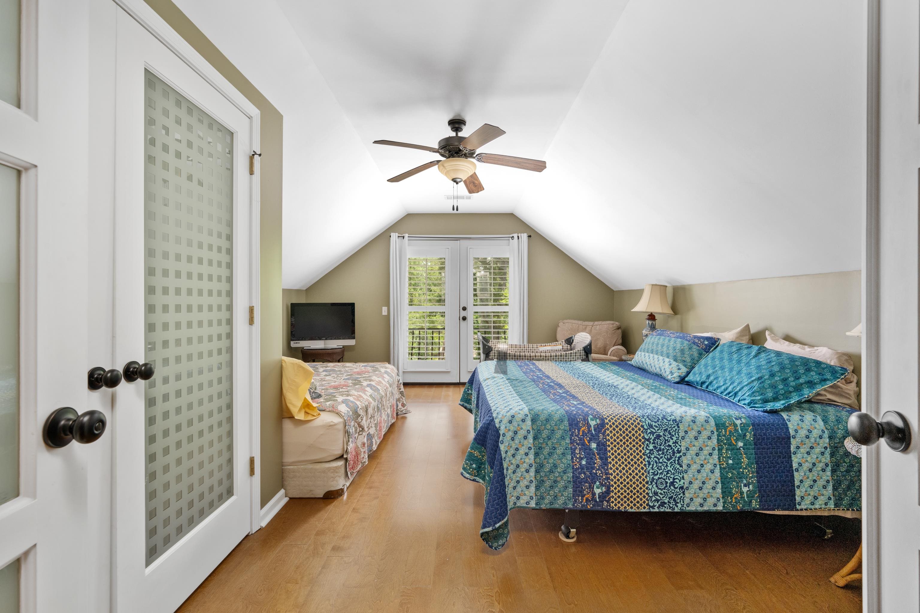 685 River Cliff Lane Counce, TN 38326 - Photo 27 of 39 a bedroom with a bed and a chandelier fan