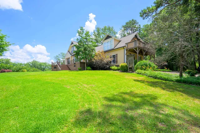 a front view of house with yard and green space