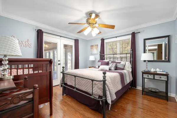 a bedroom with a bed and a chandelier