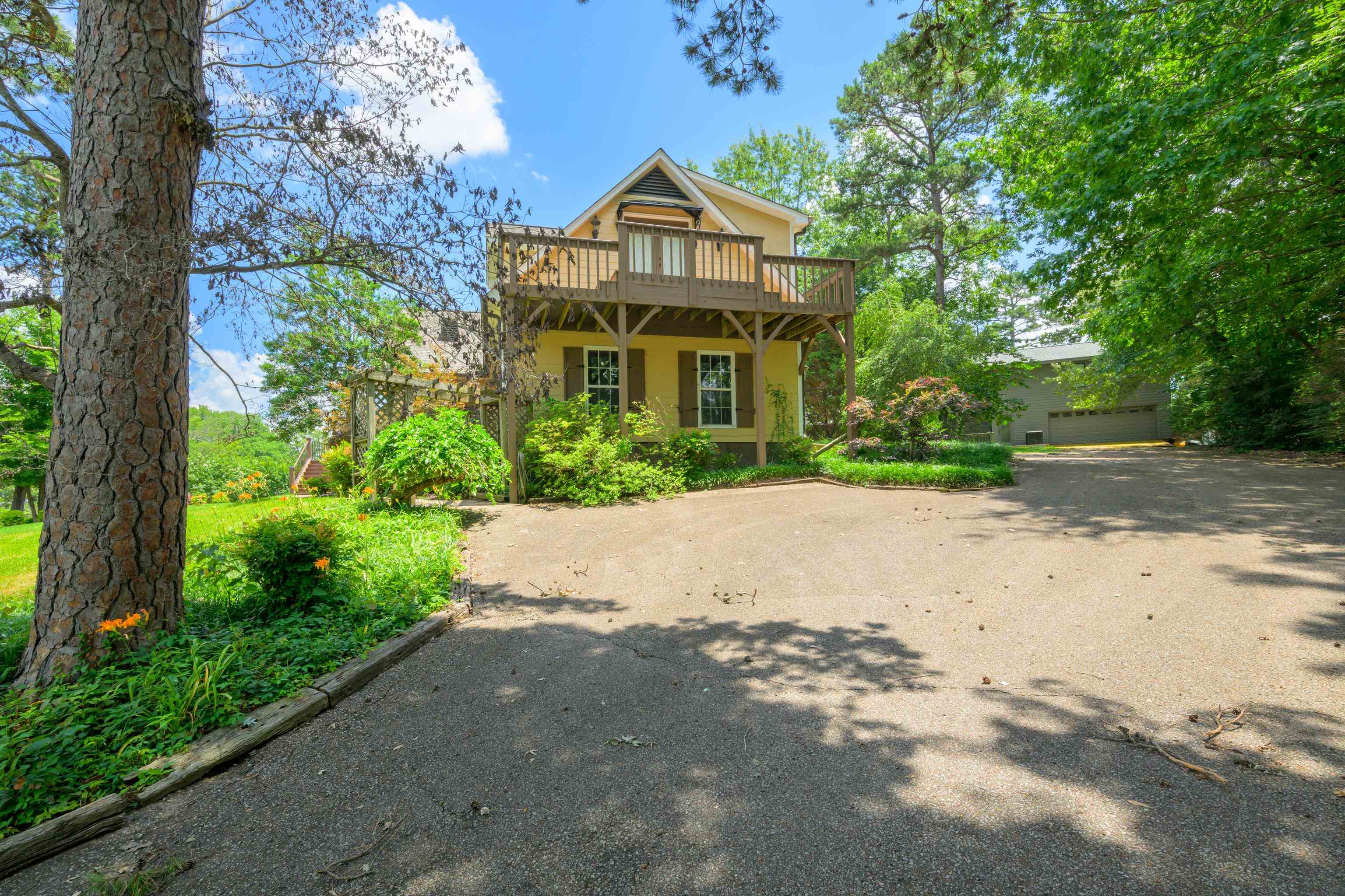 685 River Cliff Lane Counce, TN 38326 - Photo 35 of 39 a front view of a house with a yard and trees