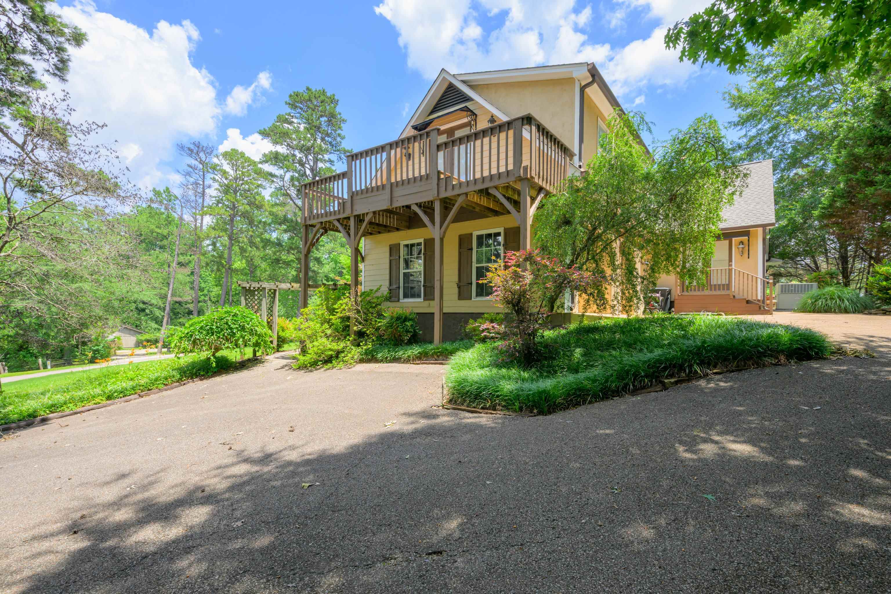 685 River Cliff Lane Counce, TN 38326 - Photo 4 of 39 a view of a white house with large windows and a small yard
