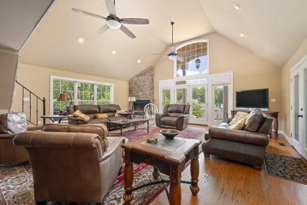 a living room with furniture fireplace and a large window