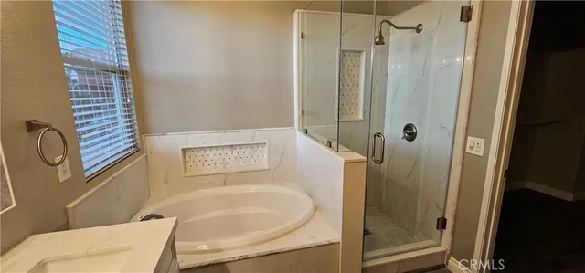 a bathroom with a shower a toilet and a sink