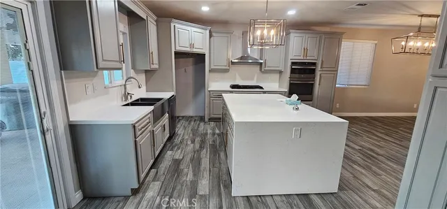 a kitchen with kitchen island a sink appliances and cabinets
