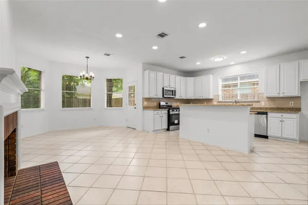 a kitchen with stainless steel appliances granite countertop a stove sink and cabinets
