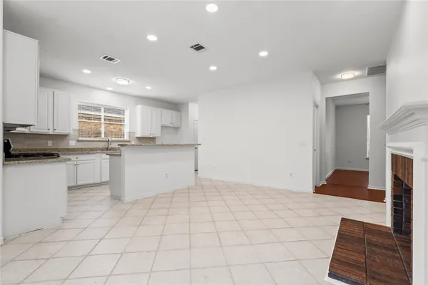 a kitchen with white cabinets a sink and white appliances