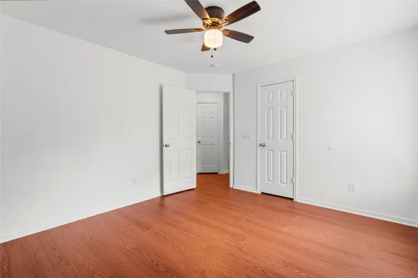 an empty room with fan and a ceiling fan