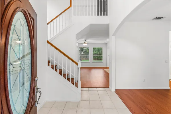 a view of a livingroom with wooden floor and stairs