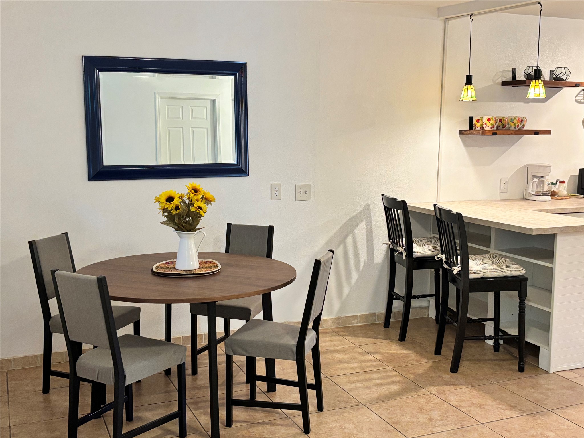 5414 Bolm Road, Unit B Austin, TX 78721 - Photo 2 of 8 A well-lit dining area offers a cozy breakfast bar and functional kitchen access.