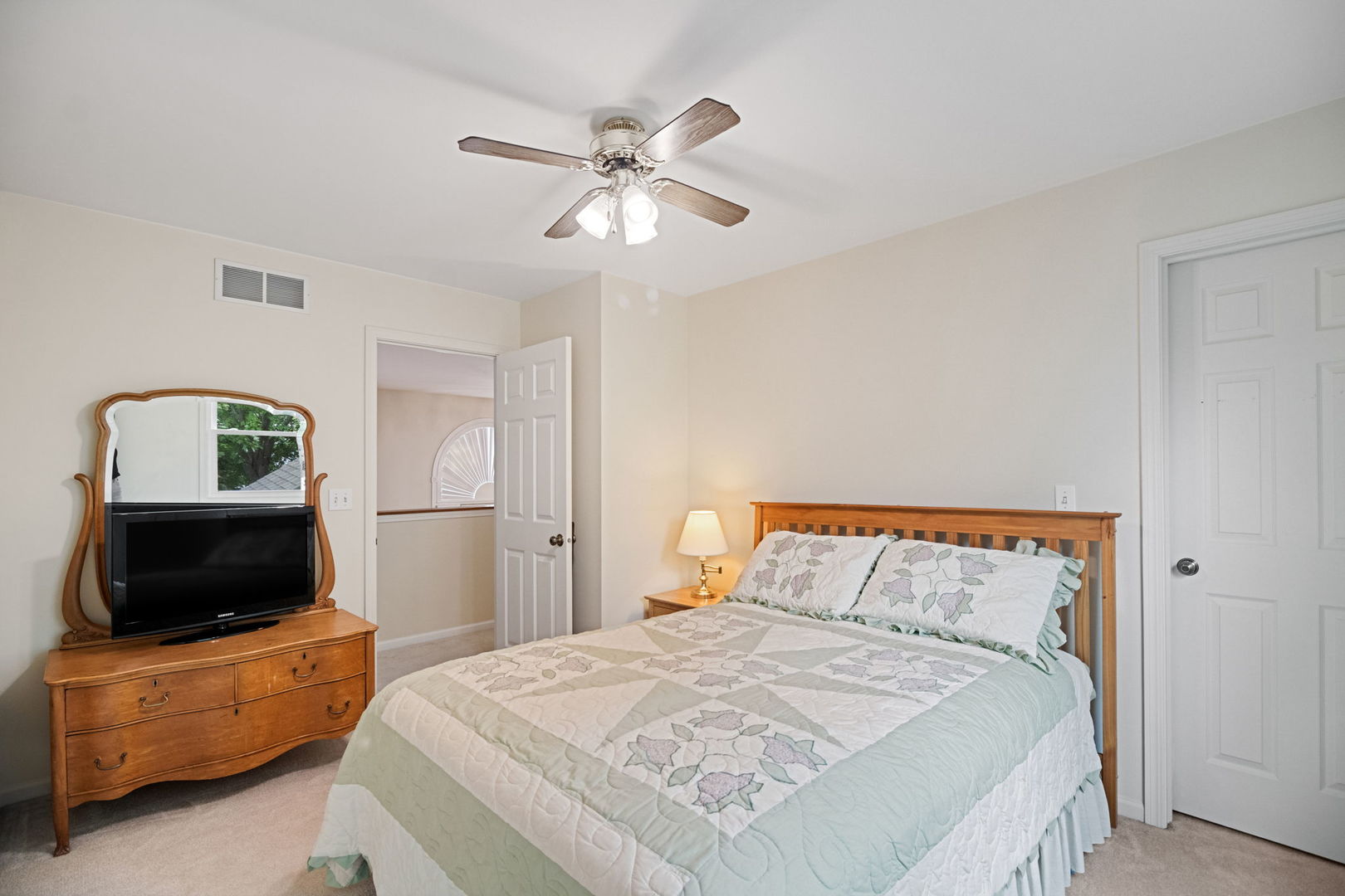 145 Barnes Road Elgin, IL 60124 - Photo 12 of 45 a bedroom with a bed a couch and a flat screen tv