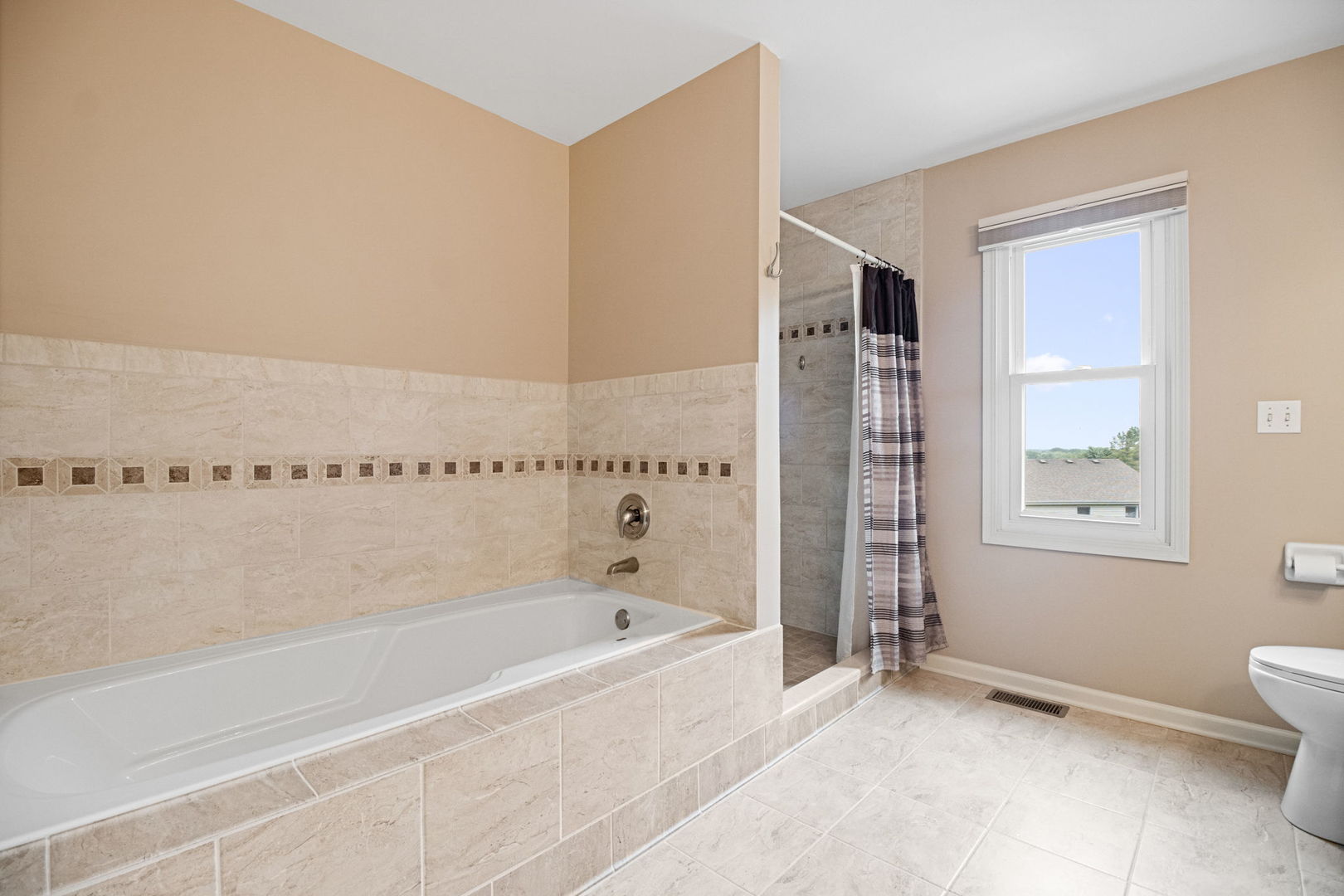 145 Barnes Road Elgin, IL 60124 - Photo 17 of 45 a bathroom with a bathtub and a shower