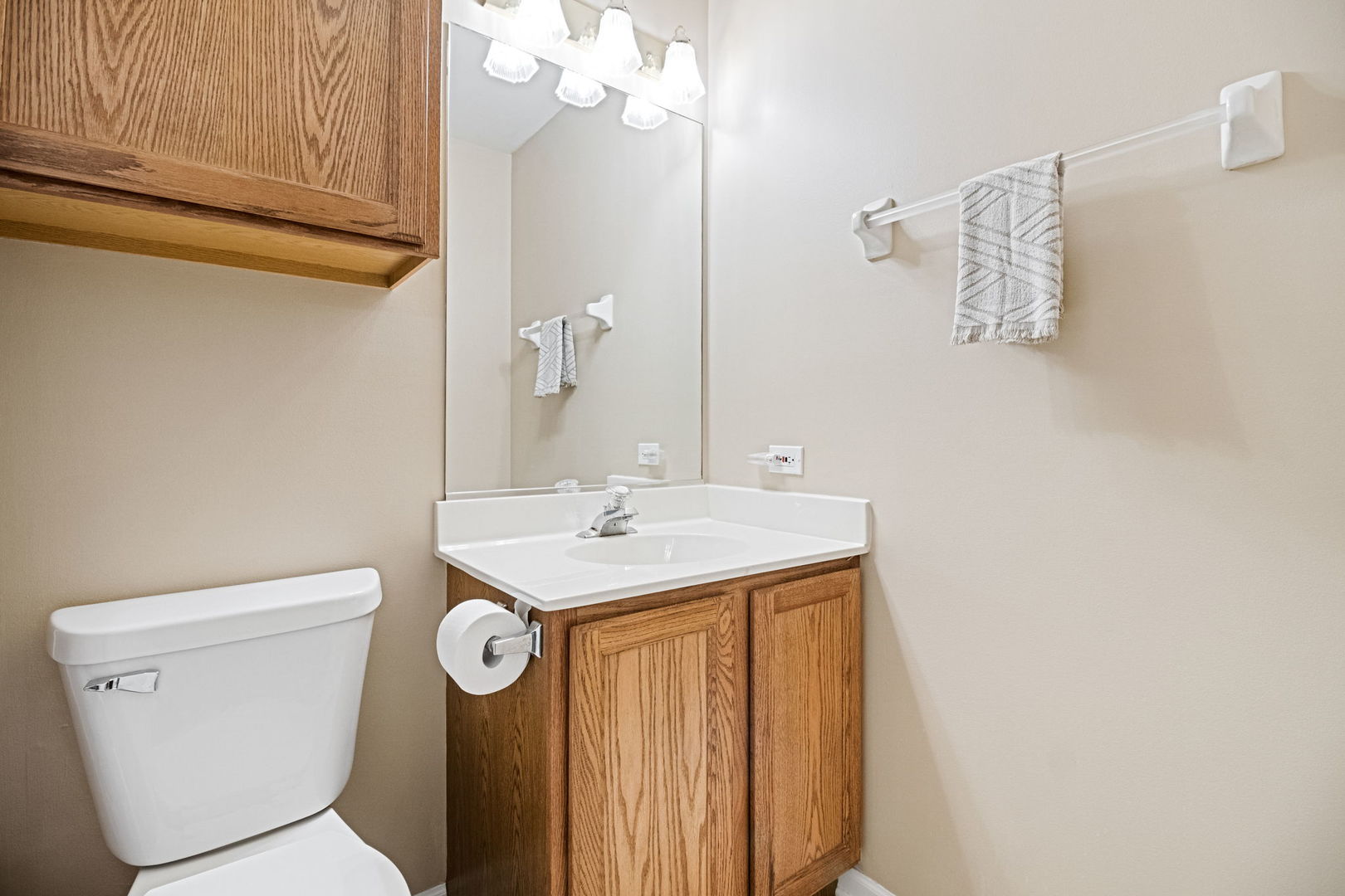 145 Barnes Road Elgin, IL 60124 - Photo 23 of 45 a bathroom with a toilet a sink and a mirror