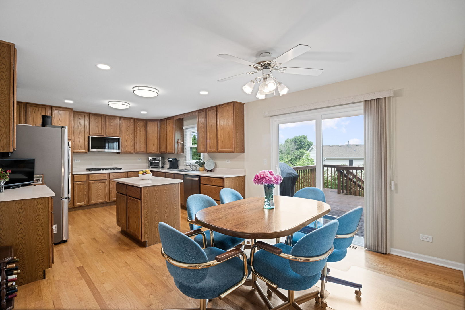 145 Barnes Road Elgin, IL 60124 - Photo 33 of 45 a kitchen with a dining table chairs stainless steel appliances and cabinets