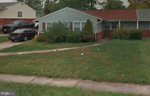 2028 Rolling Rd. Baltimore, MD 21244 - Photo 1 of 5 a front view of a house with a garden