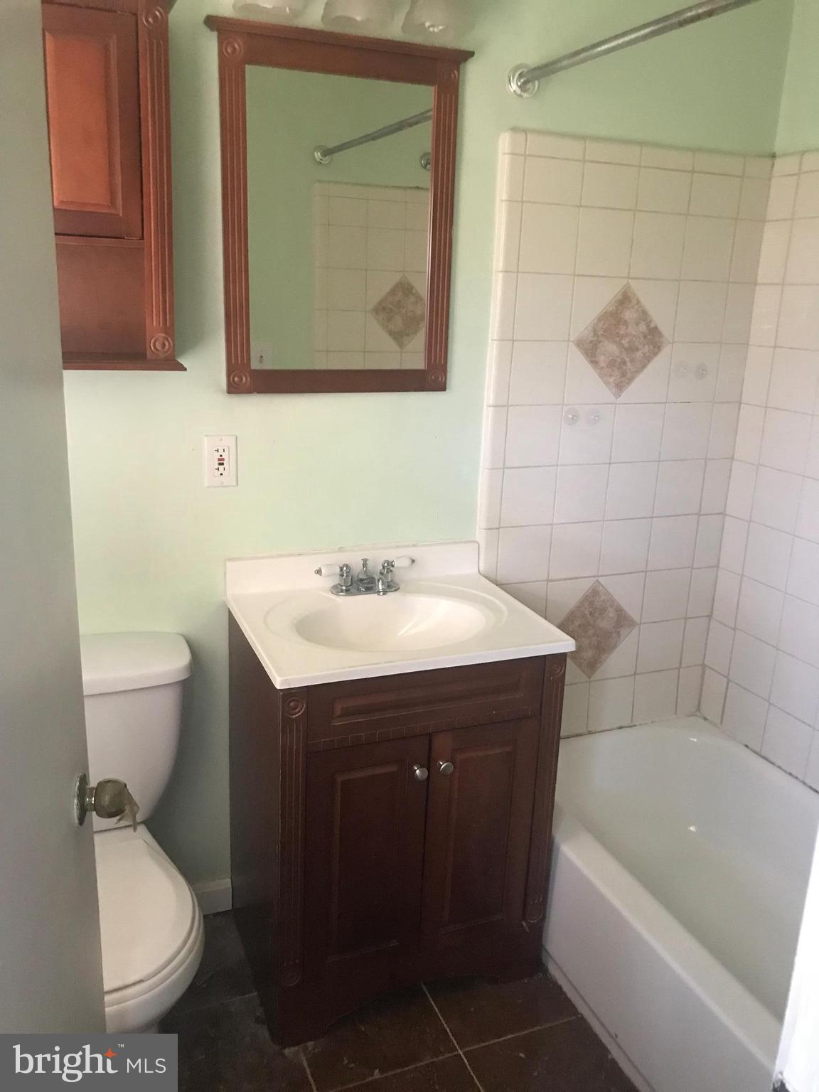 2028 Rolling Rd. Baltimore, MD 21244 - Photo 2 of 5 a bathroom with a sink toilet and shower