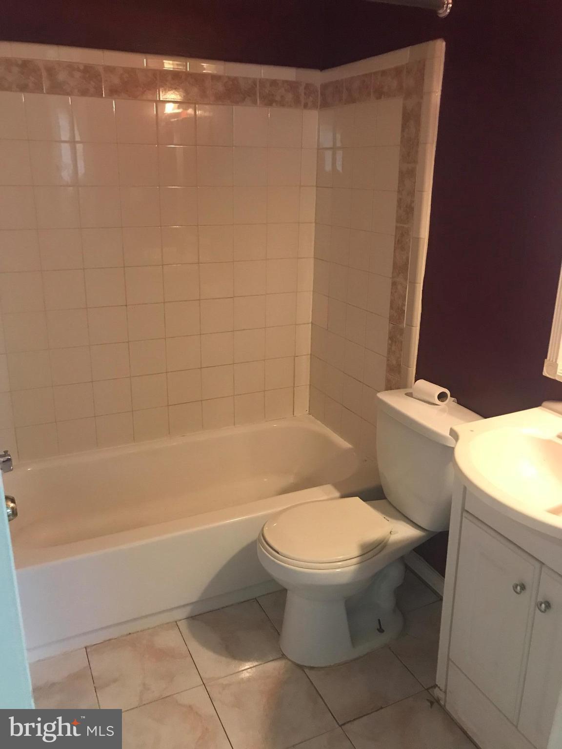 2028 Rolling Rd. Baltimore, MD 21244 - Photo 3 of 5 a bathroom with a toilet and a shower