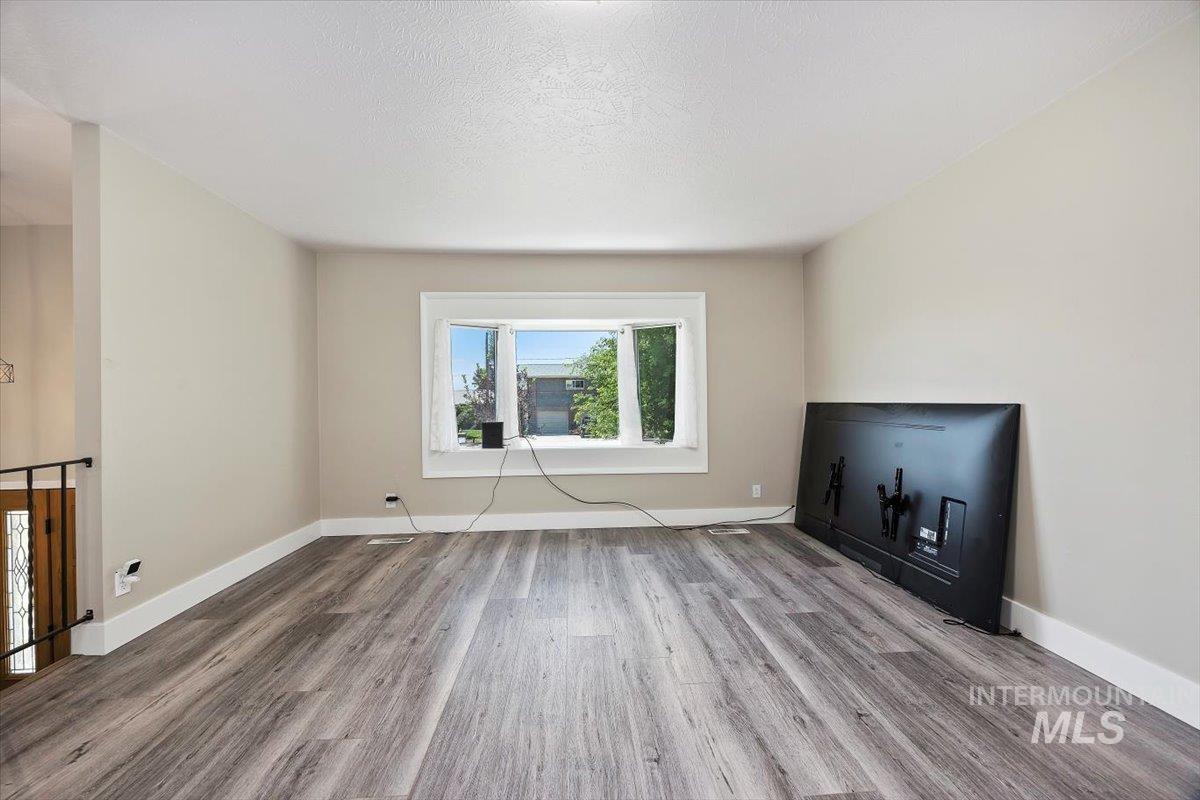 616 Doris Avenue Paul, ID 83347 - Photo 10 of 38 Unfurnished living room featuring wood finished floors