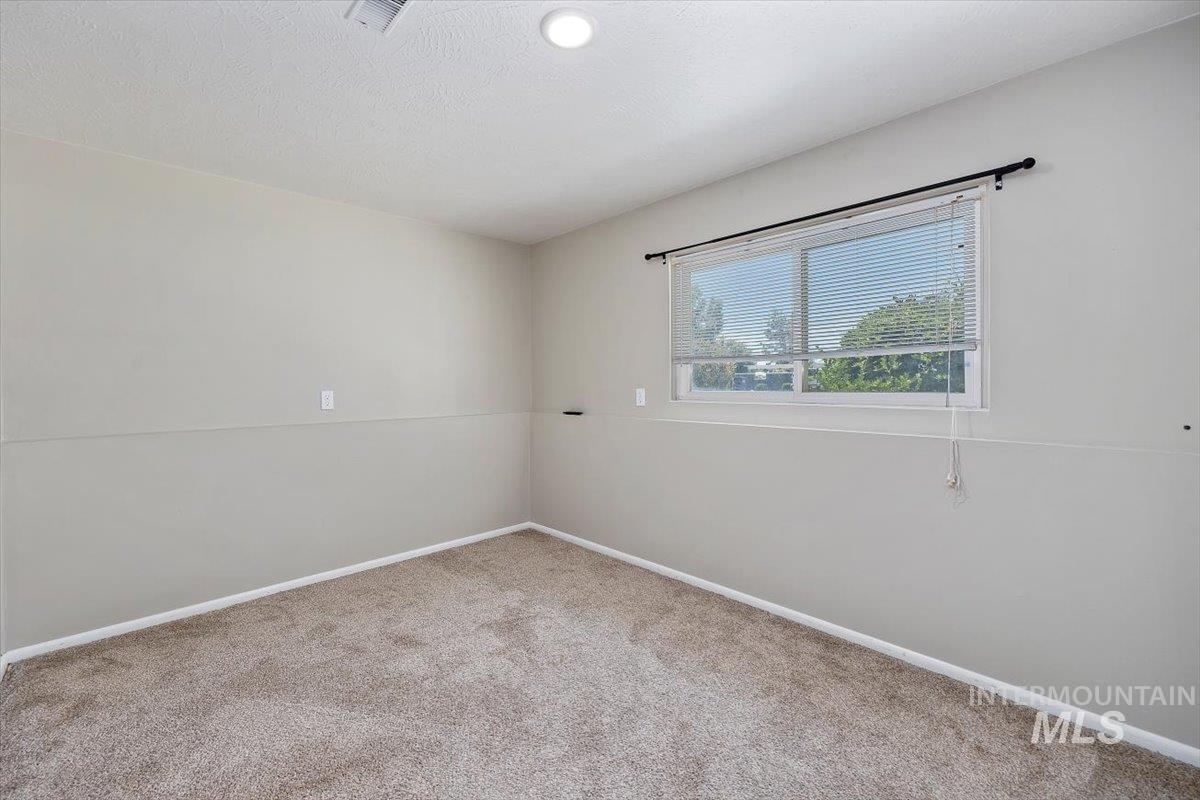 616 Doris Avenue Paul, ID 83347 - Photo 23 of 38 Empty room with carpet and baseboards
