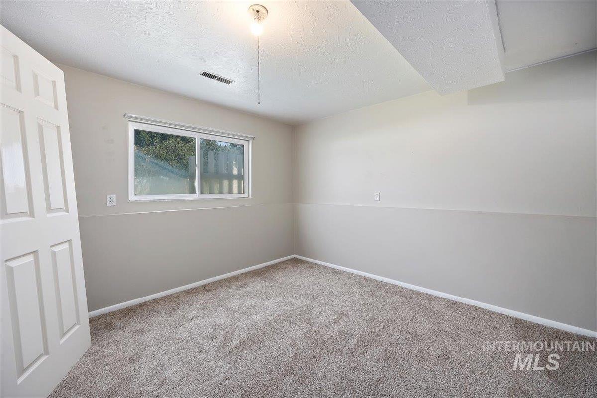616 Doris Avenue Paul, ID 83347 - Photo 25 of 38 Carpeted empty room with a textured ceiling and baseboards