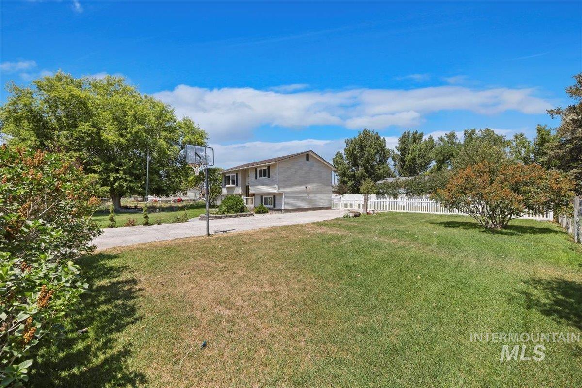 616 Doris Avenue Paul, ID 83347 - Photo 5 of 38 View of yard featuring driveway and an attached garage