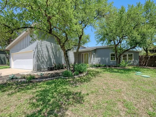 a view of a house with a backyard and a garden