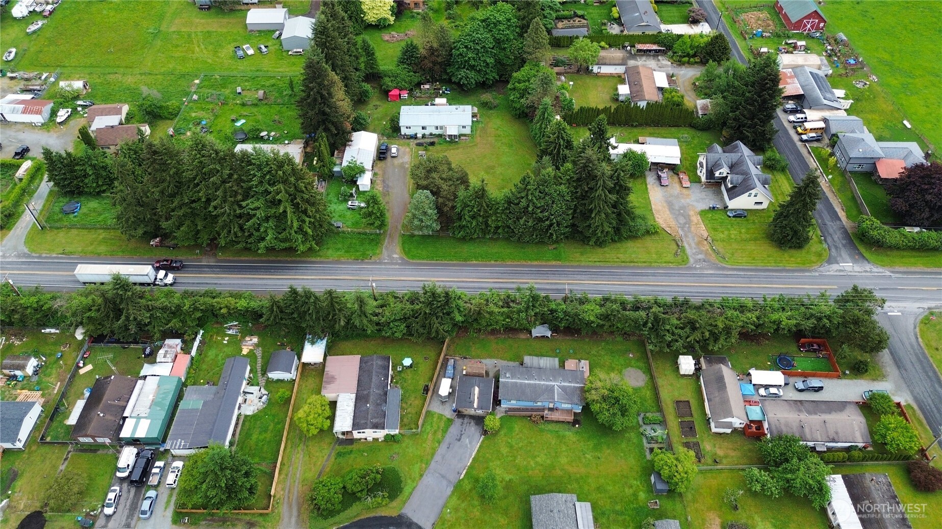 7185 Old Highway 99 North Road Burlington, WA 98233 - Photo 23 of 26 an aerial view of a house with swimming pool outdoor seating and yard