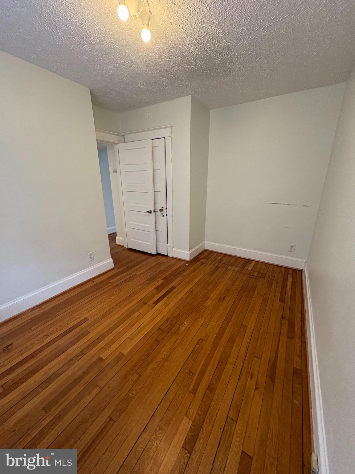 523 24th Street South Arlington, VA 22202 - Photo 15 of 18 a view of an empty room with wooden floor