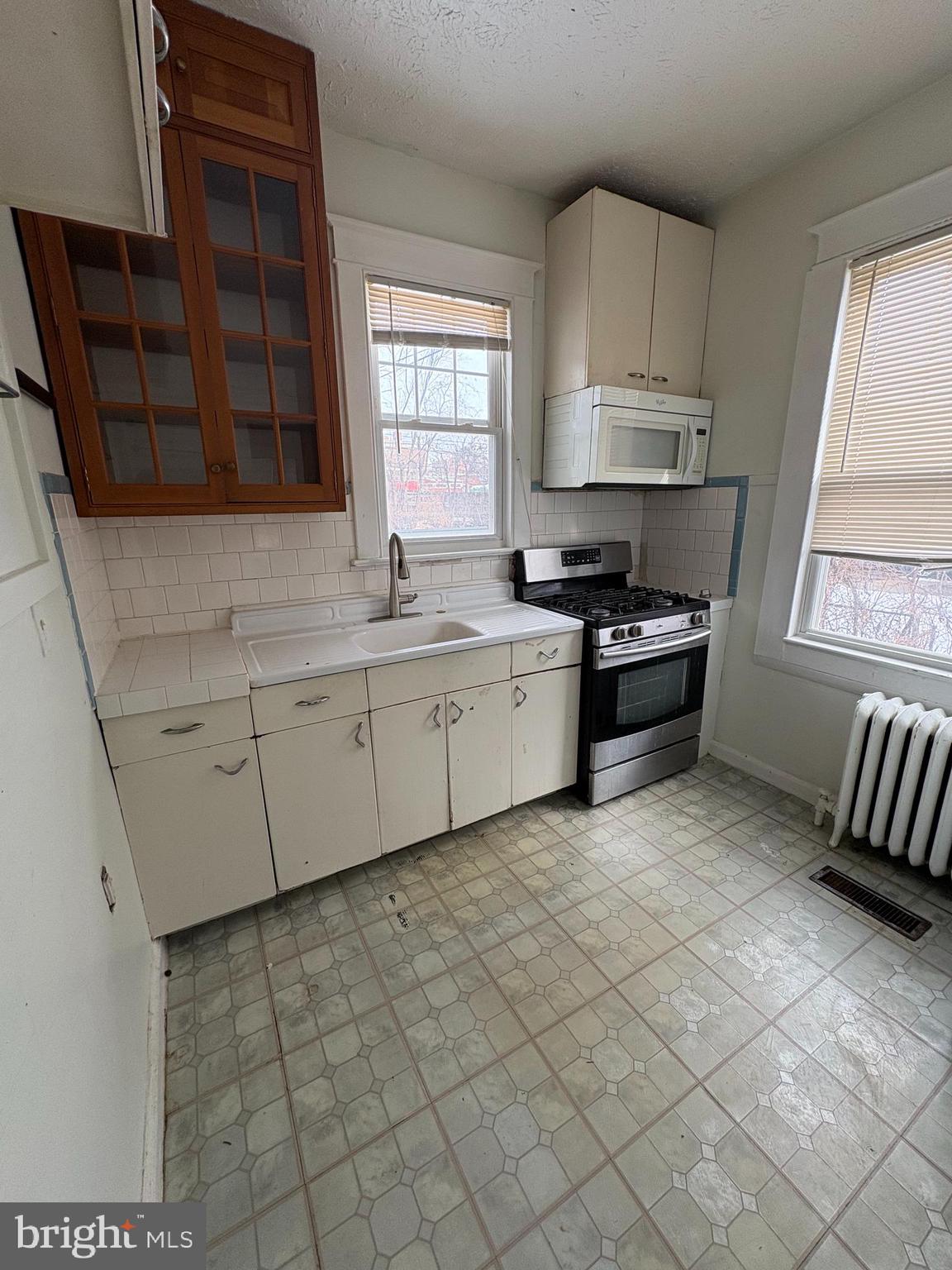 523 24th Street South Arlington, VA 22202 - Photo 4 of 18 a kitchen with stainless steel appliances granite countertop a sink stove and cabinets
