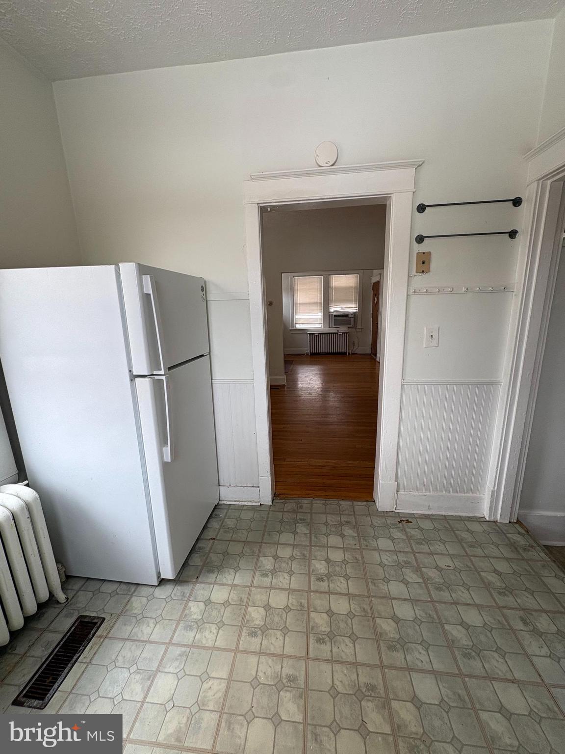 523 24th Street South Arlington, VA 22202 - Photo 5 of 18 a view of a refrigerator in kitchen and an empty room