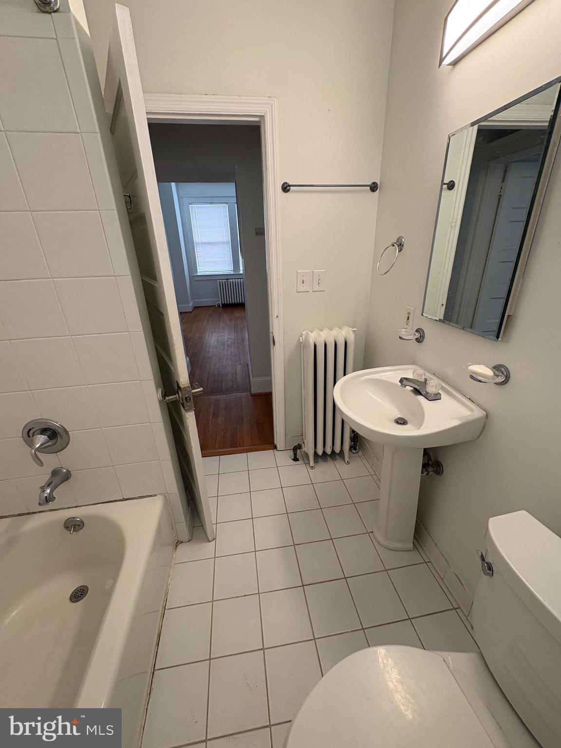 523 24th Street South Arlington, VA 22202 - Photo 8 of 18 a bathroom with a sink a toilet and mirror
