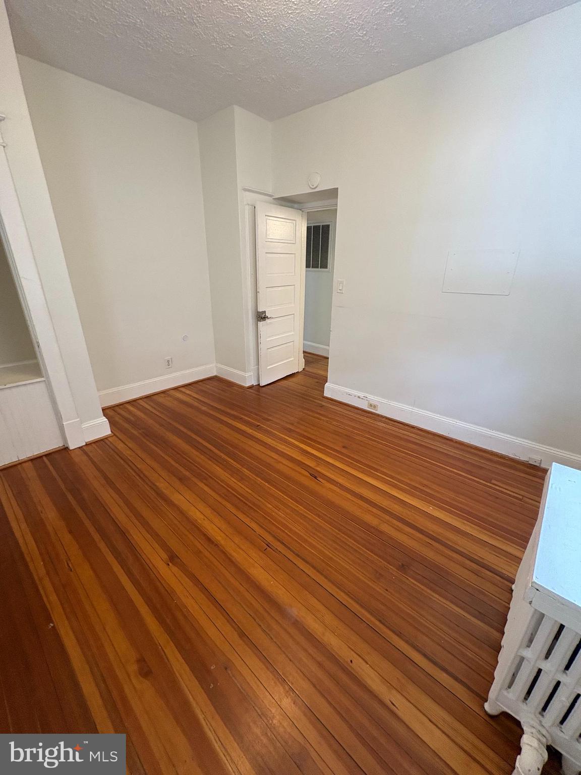 523 24th Street South Arlington, VA 22202 - Photo 10 of 18 a view of an empty room with wooden floor and a window