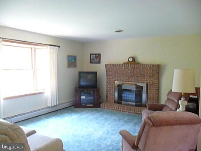 1130 Cox Road Huntingtown, MD 20639 - Photo 9 of 30 a living room with furniture and a fireplace