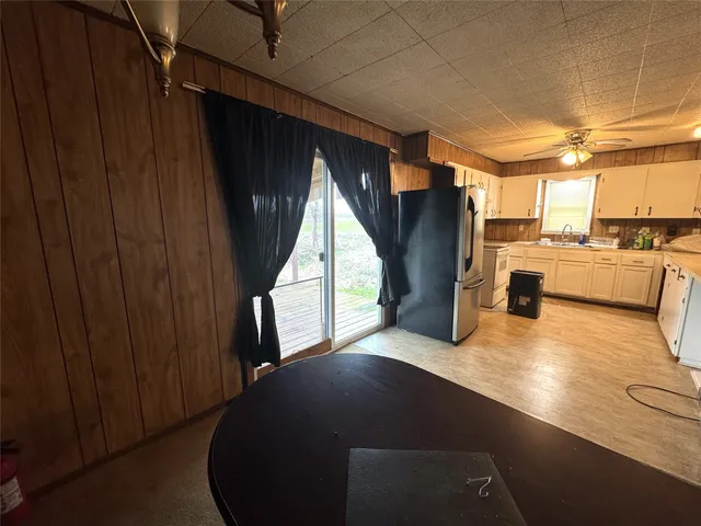 a white refrigerator freezer and a stove sitting inside of a kitchen