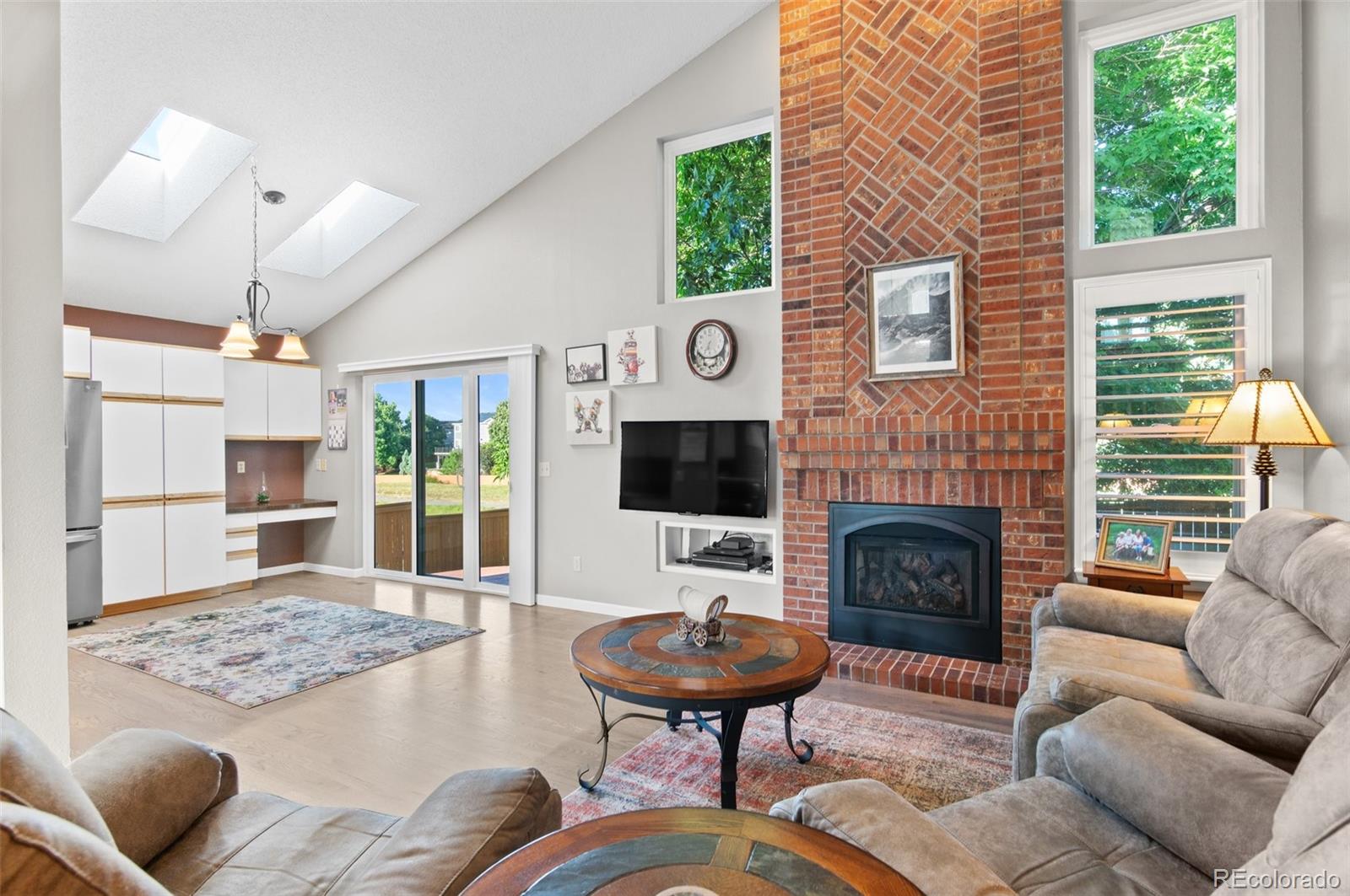9836 Buckingham Court Highlands Ranch, CO 80130 - Photo 14 of 42 a living room with furniture and a fireplace