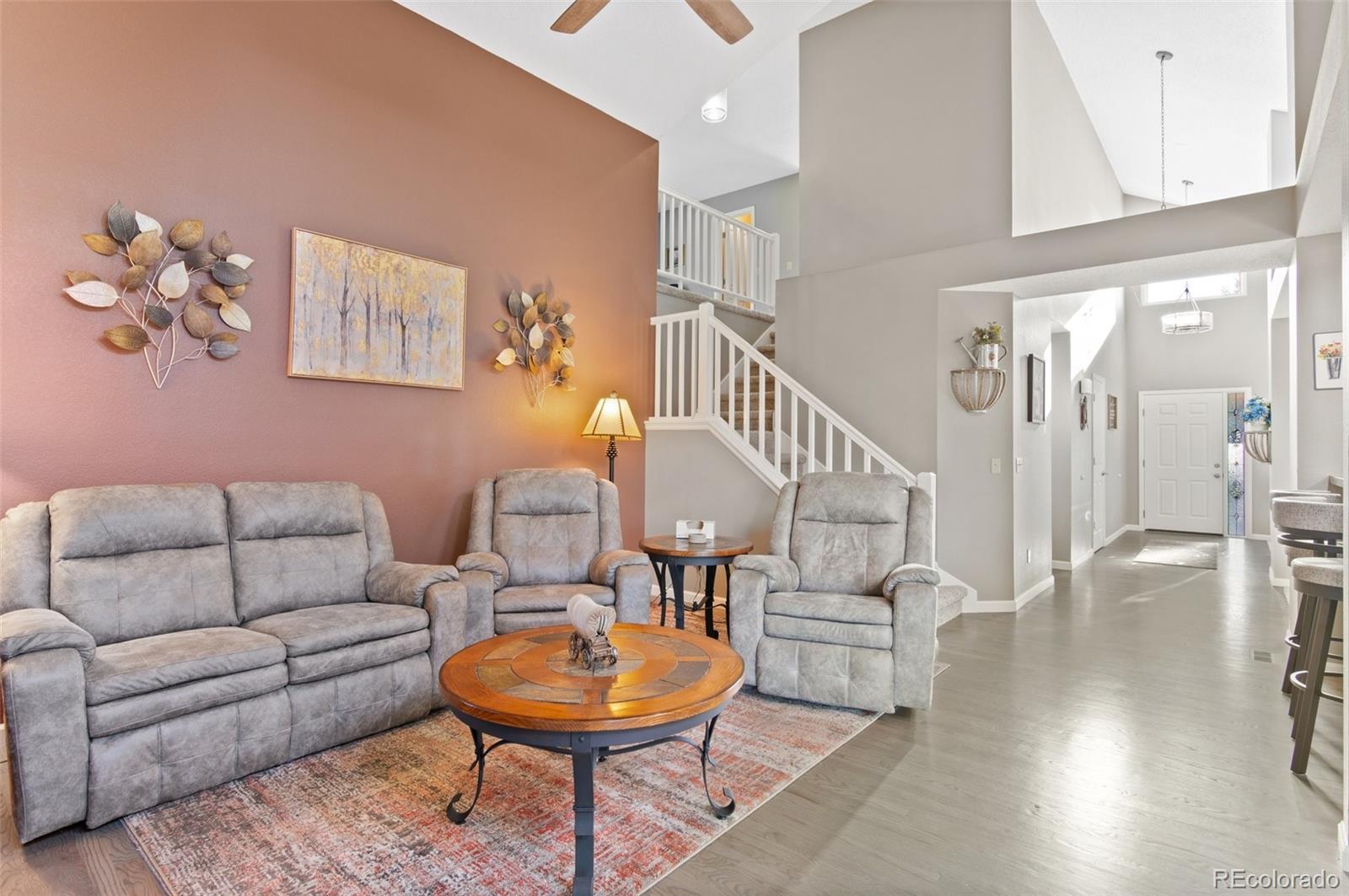 9836 Buckingham Court Highlands Ranch, CO 80130 - Photo 15 of 42 a living room with furniture and a wooden floor