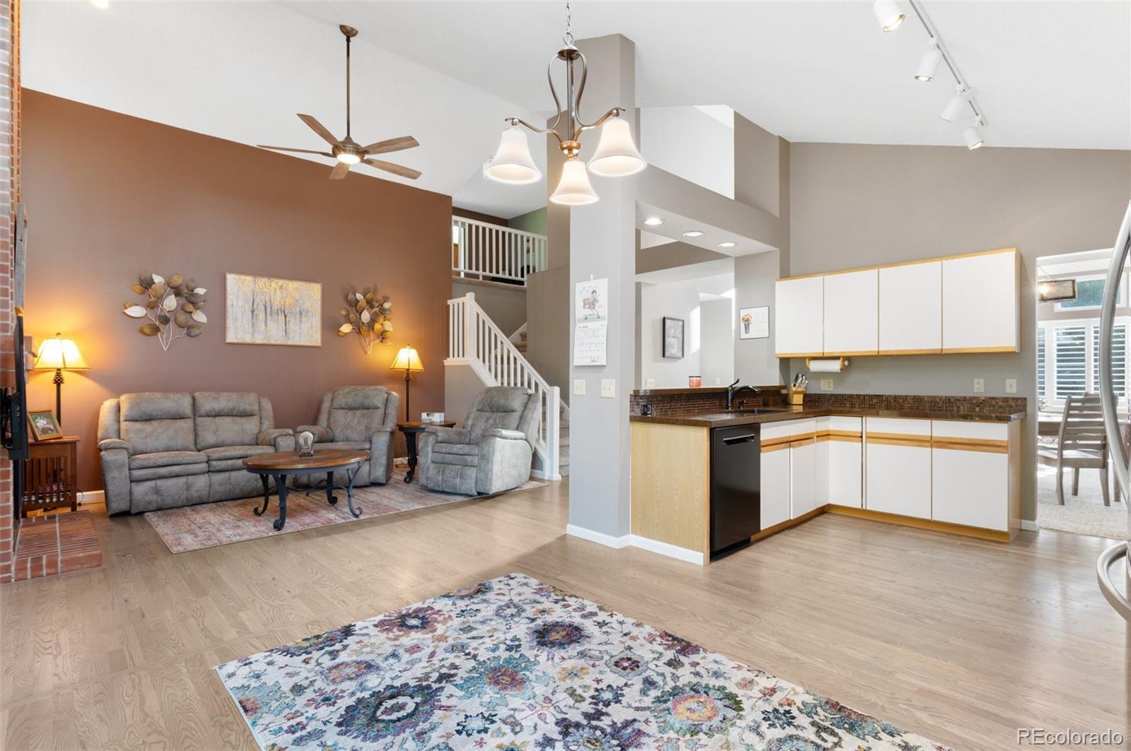 9836 Buckingham Court Highlands Ranch, CO 80130 - Photo 17 of 42 a large white kitchen with lots of counter space a sink and appliances