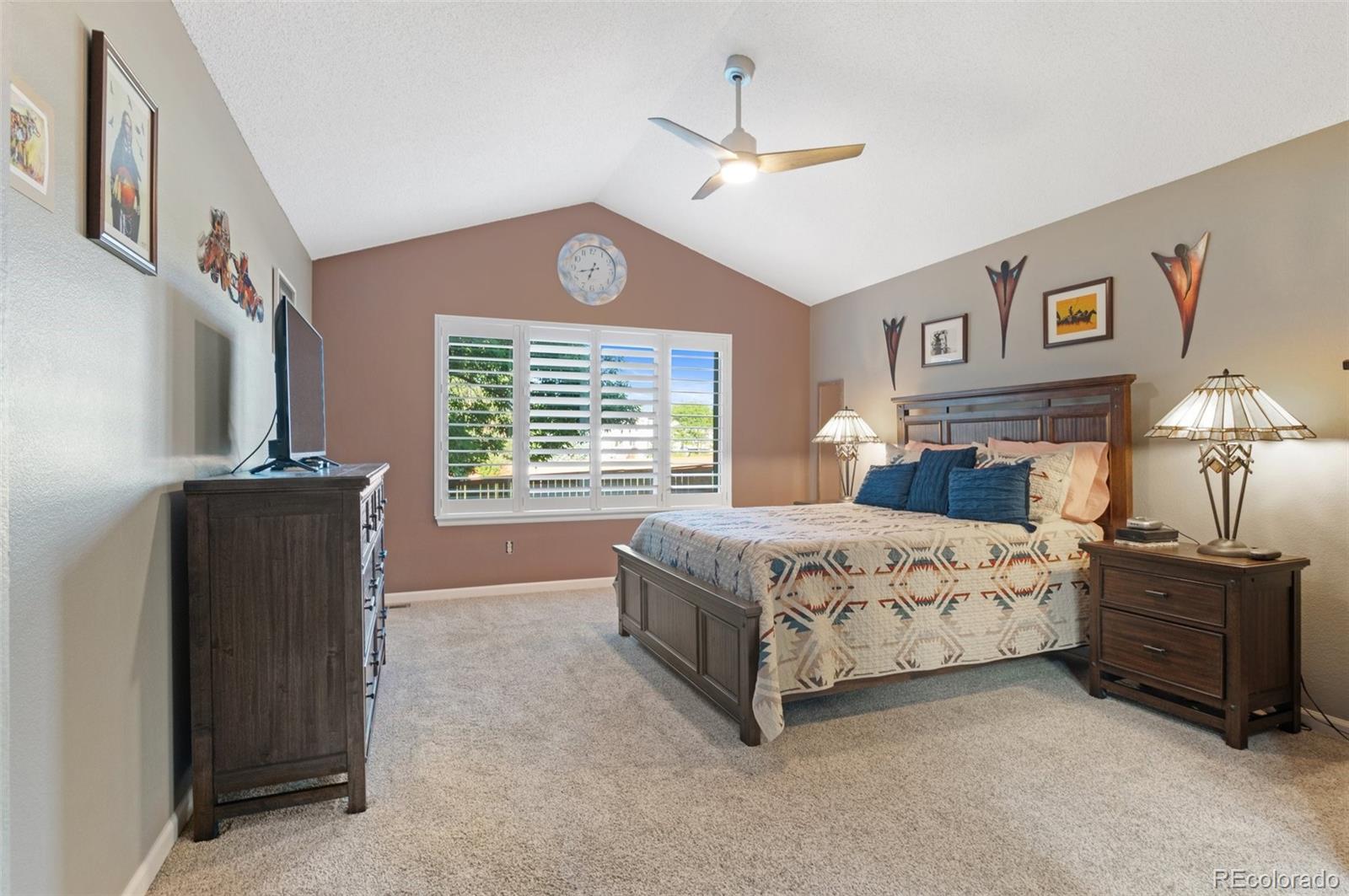 9836 Buckingham Court Highlands Ranch, CO 80130 - Photo 25 of 42 a bedroom with a bed and a chandelier