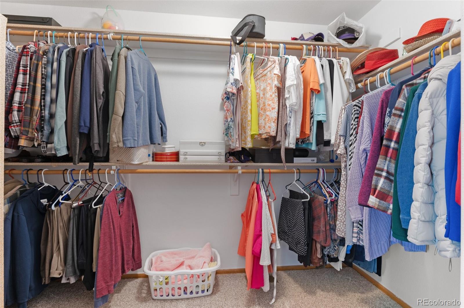 9836 Buckingham Court Highlands Ranch, CO 80130 - Photo 29 of 42 a view of walk in closet with clothes and shoes
