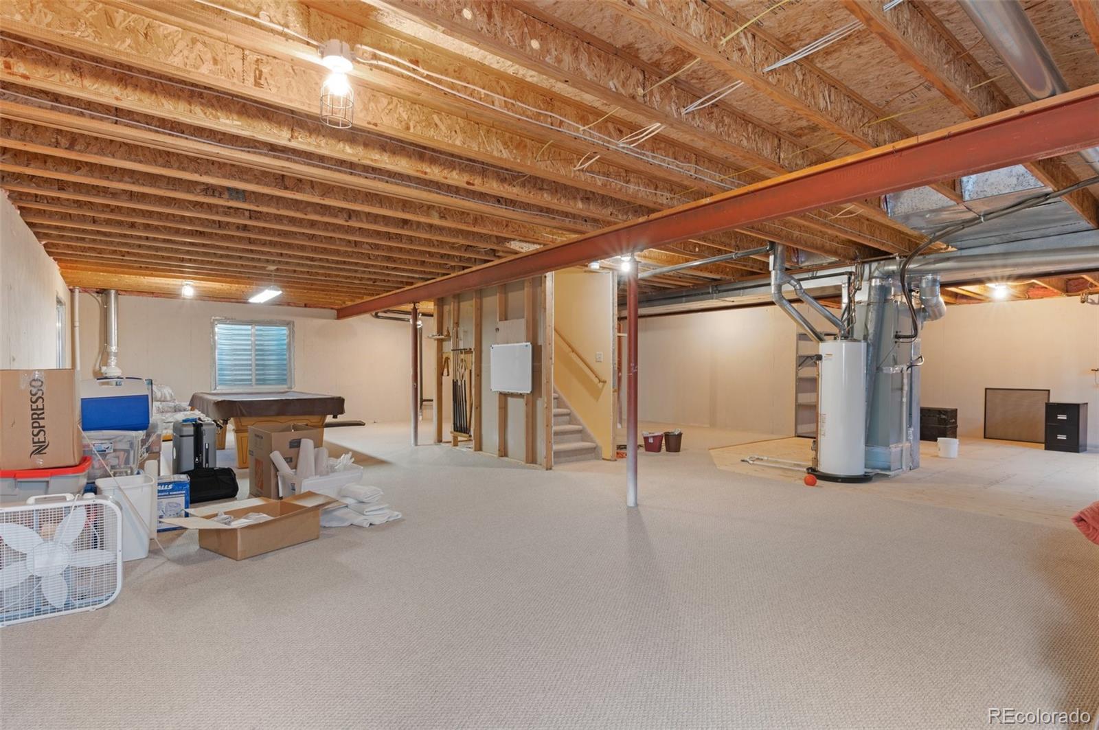 9836 Buckingham Court Highlands Ranch, CO 80130 - Photo 30 of 42 a view of a big room with air conditioner duct and materials on floor