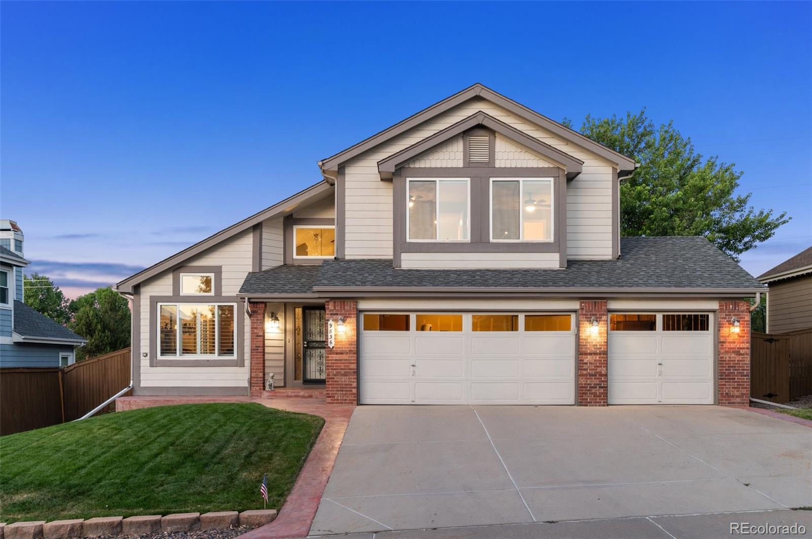 9836 Buckingham Court Highlands Ranch, CO 80130 - Photo 3 of 42 a front view of a house with a yard