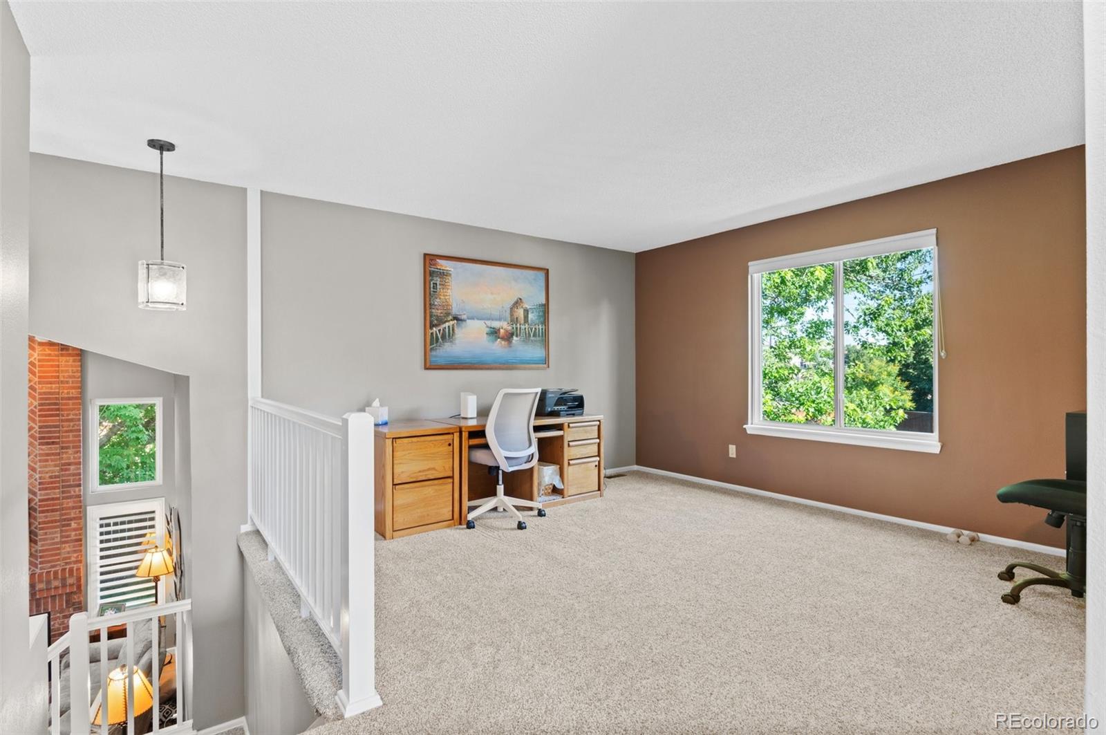 9836 Buckingham Court Highlands Ranch, CO 80130 - Photo 31 of 42 a living room with furniture and a window