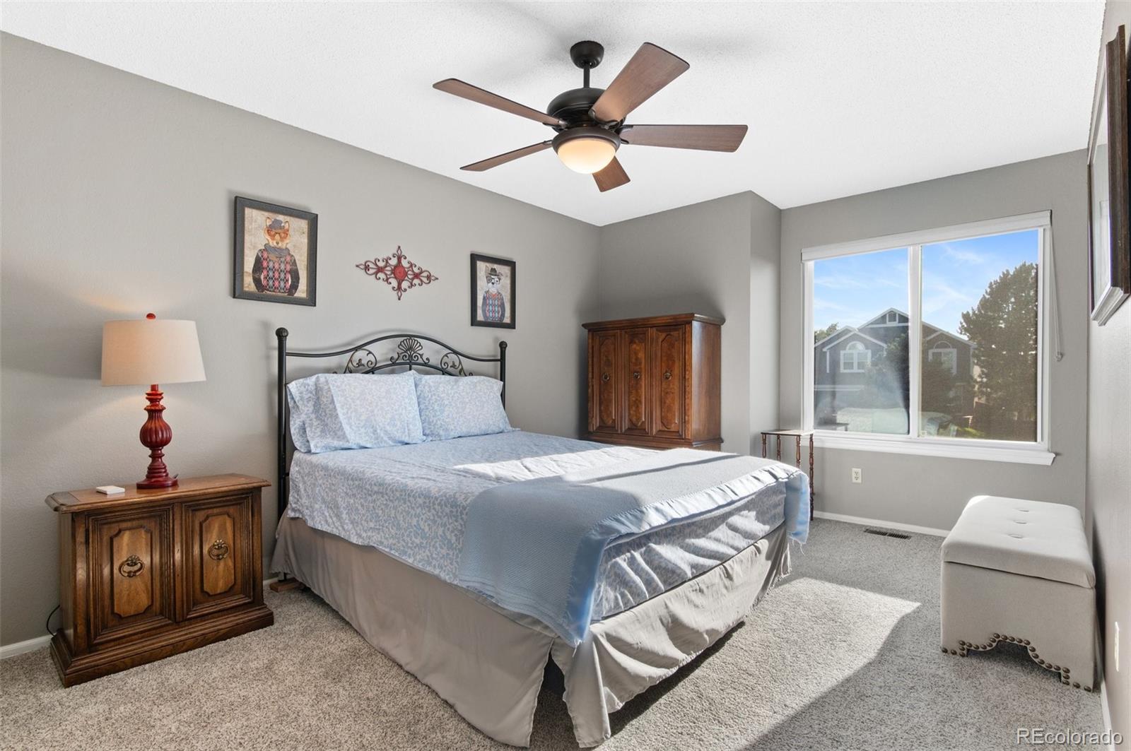 9836 Buckingham Court Highlands Ranch, CO 80130 - Photo 35 of 42 a bedroom with a bed and a chandelier