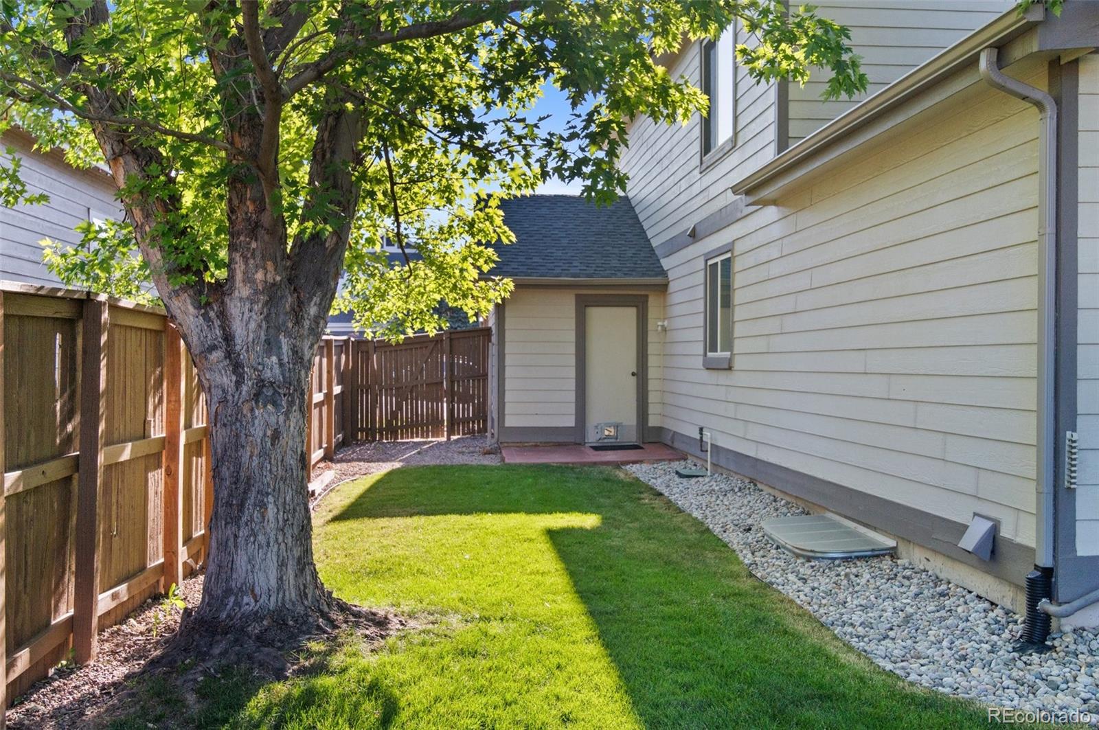 9836 Buckingham Court Highlands Ranch, CO 80130 - Photo 37 of 42 a view of a backyard with a small cabin