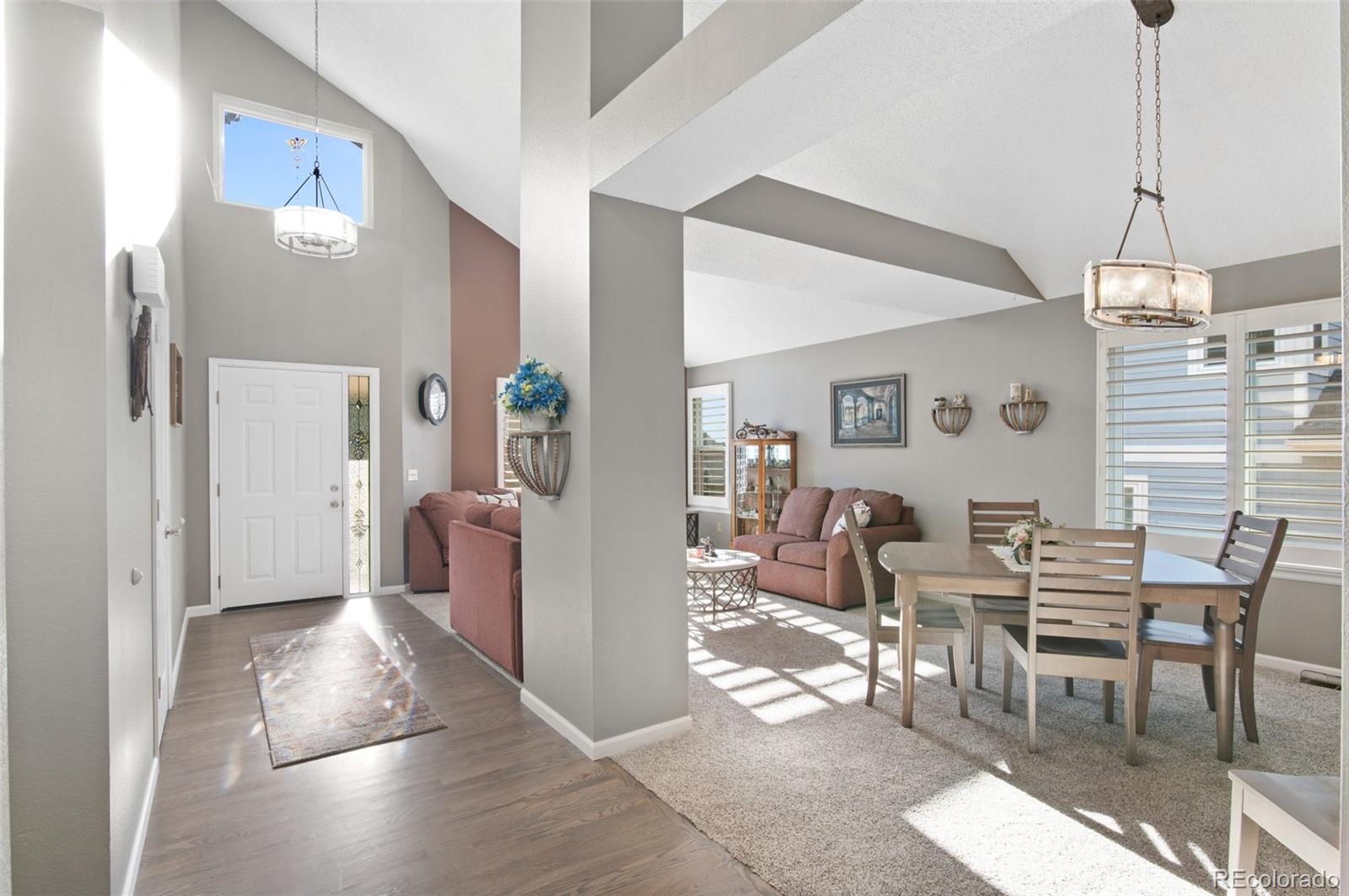 9836 Buckingham Court Highlands Ranch, CO 80130 - Photo 5 of 42 a view of a a dining room with furniture window and wooden floor