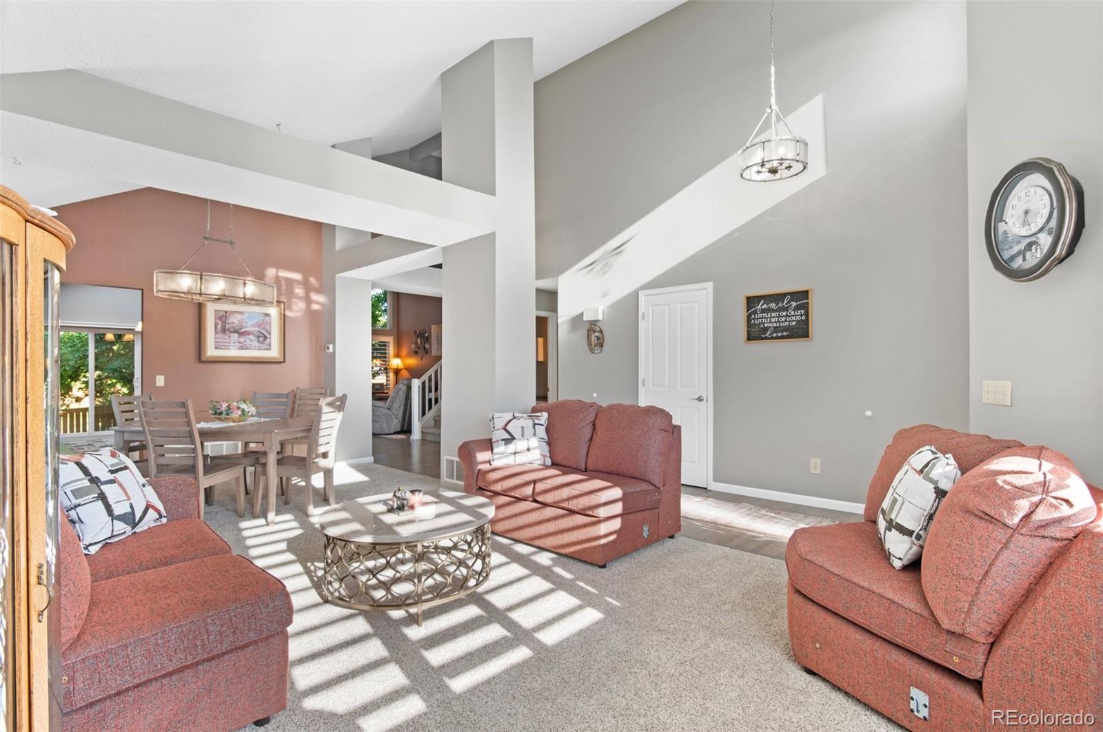 9836 Buckingham Court Highlands Ranch, CO 80130 - Photo 7 of 42 a living room with furniture rug and wooden floor
