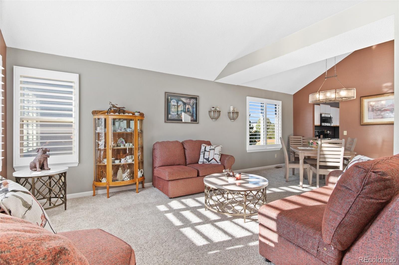9836 Buckingham Court Highlands Ranch, CO 80130 - Photo 8 of 42 a living room with furniture and a window