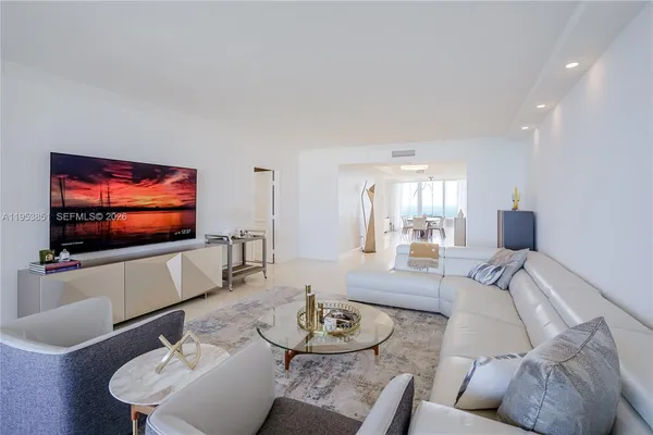 a living room with furniture a rug and a flat screen tv