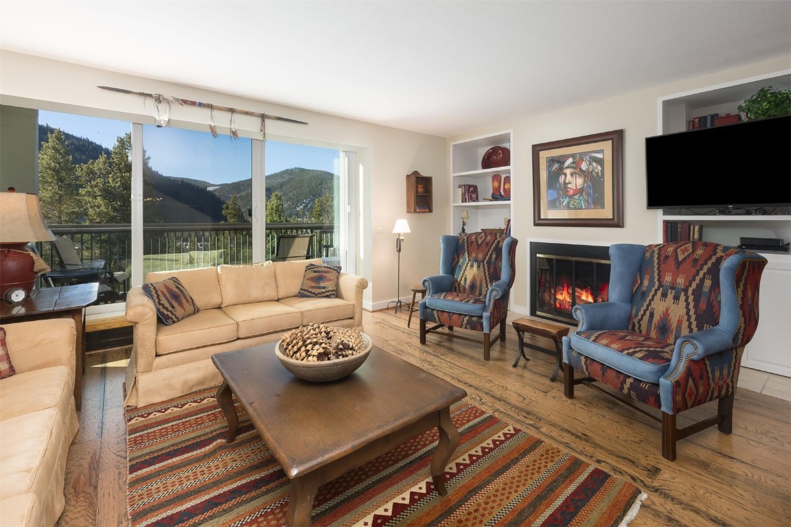22097 Saints John Road, Unit 2526 Keystone, CO 80435 - Photo 1 of 42 a living room with furniture a flat screen tv and a fireplace