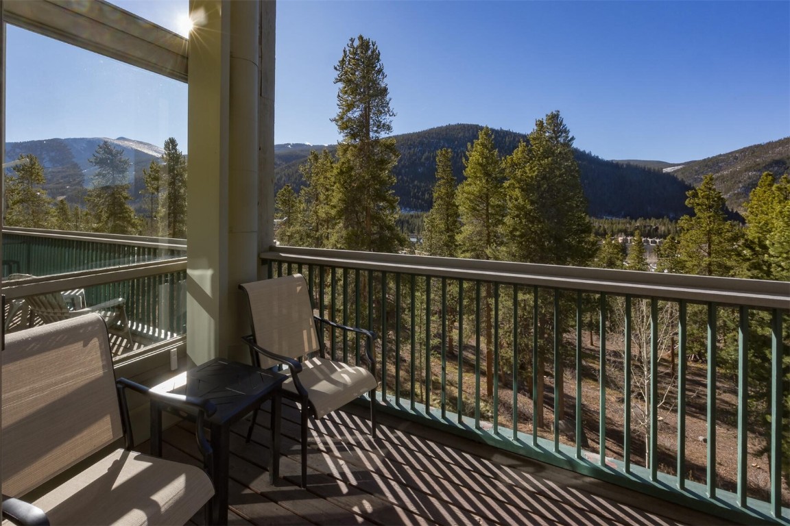 22097 Saints John Road, Unit 2526 Keystone, CO 80435 - Photo 13 of 42 a view of a balcony with wooden floor and outdoor seating